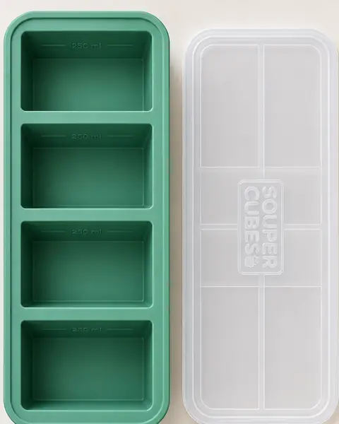 Souper Cubes tray from above, showing four 250 ml cubes, next to its lid